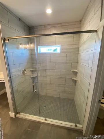 a bathroom with a glass shower door