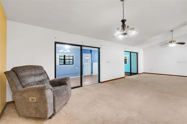 a living room with furniture and chandelier