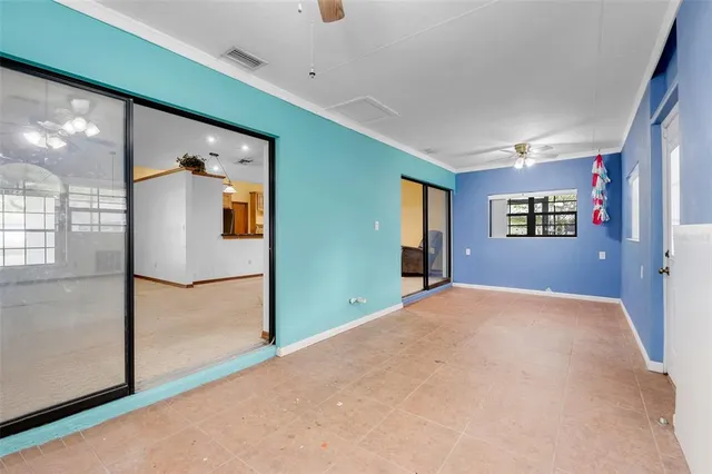 a view of a hallway with wooden floor and windows