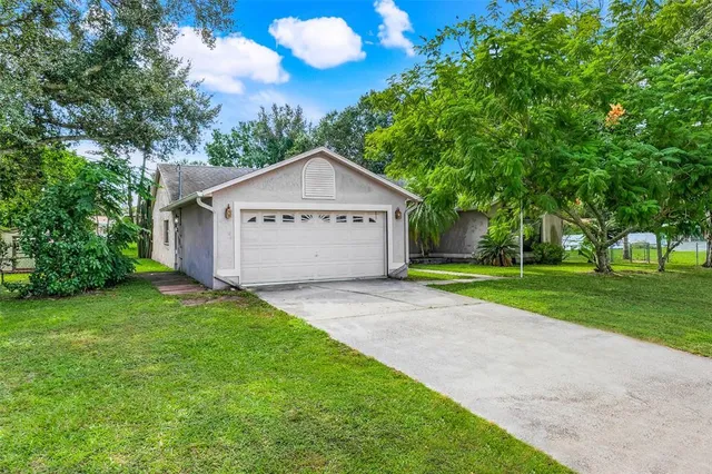 a view of green field with trees in the background
