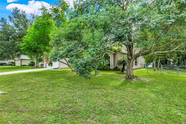 a backyard of a house with lots of green space