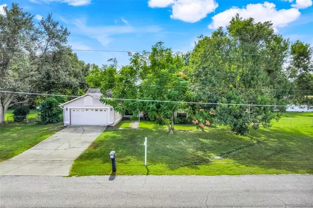 an aerial view of a house with a yard