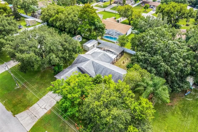 a backyard of a house with a yard and potted plants