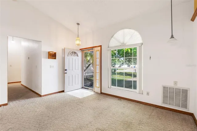 a view of livingroom with furniture window and front door