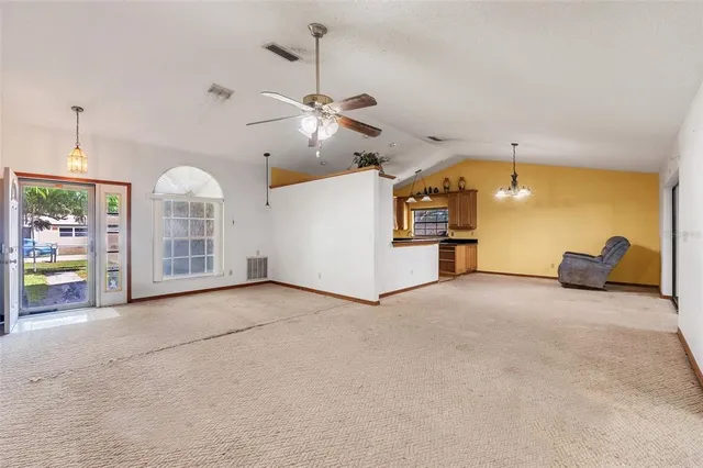 a view of a kitchen with furniture and a ceiling fan