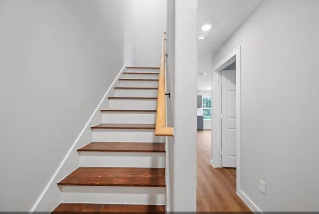 a view of entryway and hall with wooden floor