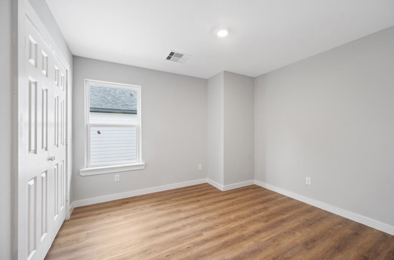 6617 Bacher Street, Unit B Houston, TX 77028 - Photo 15 of 25 a view of empty room with wooden floor and fan