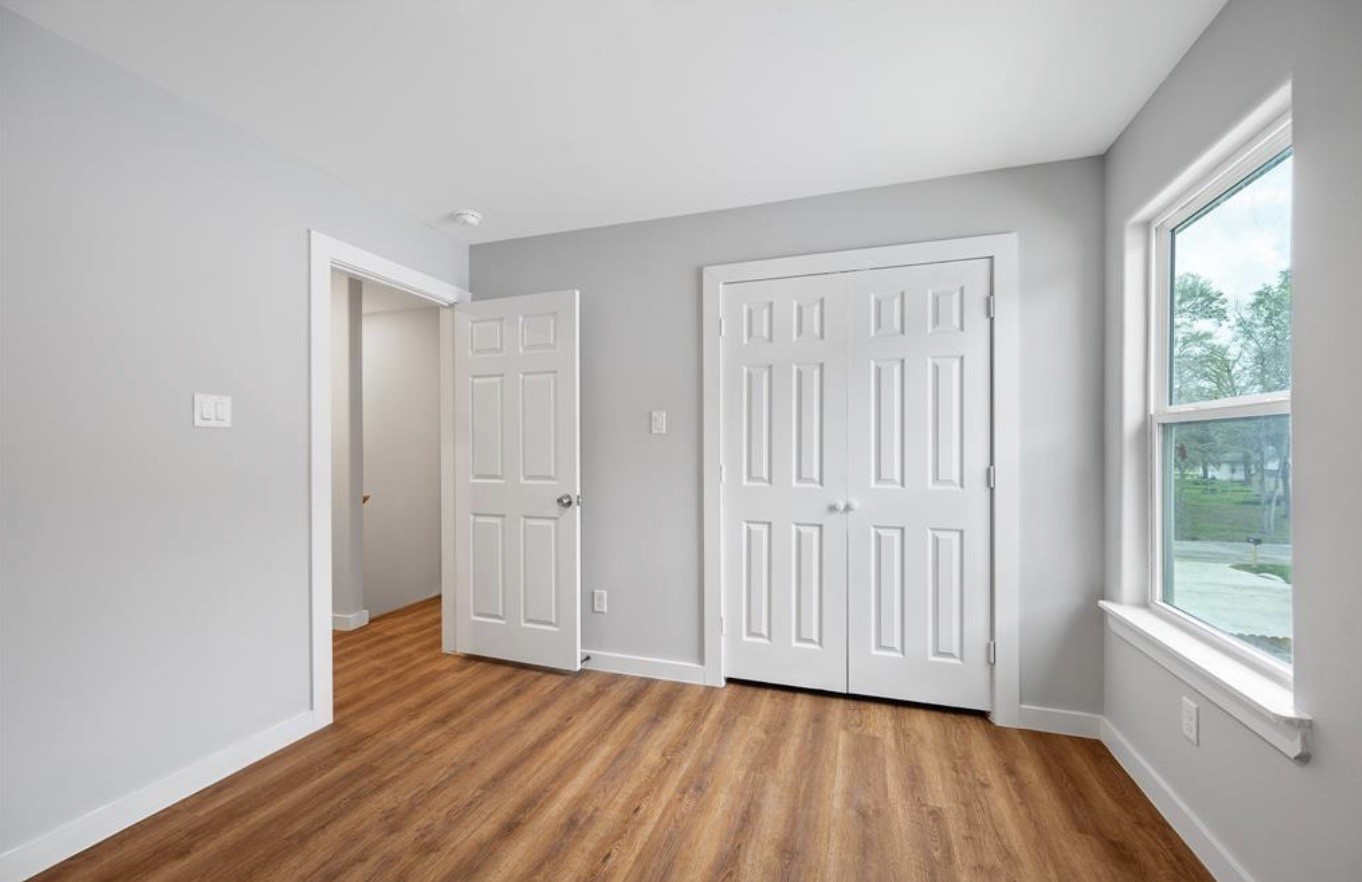 6617 Bacher Street, Unit B Houston, TX 77028 - Photo 16 of 25 a view of empty room with wooden floor and fan