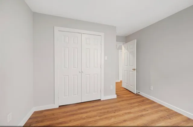 a view of an empty room and wooden floor