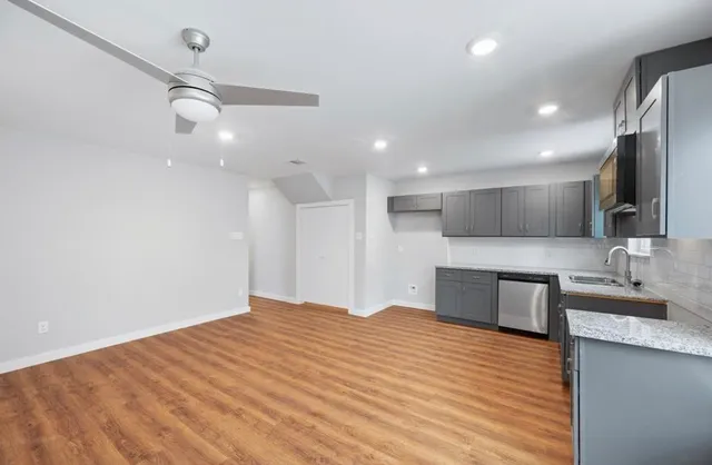 a large kitchen with kitchen island a sink stainless steel appliances and cabinets