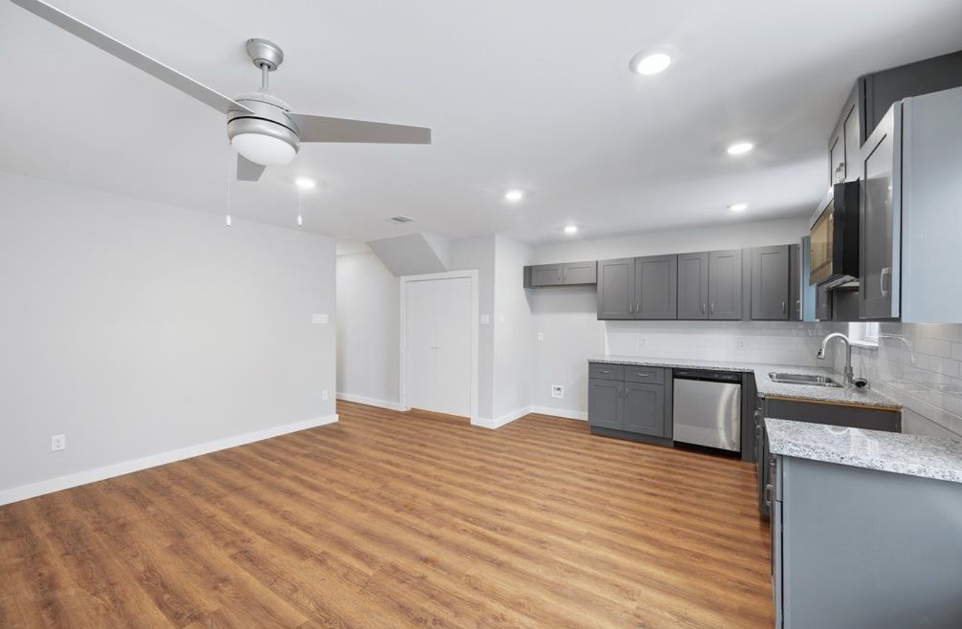 6617 Bacher Street, Unit B Houston, TX 77028 - Photo 3 of 25 a large kitchen with kitchen island a sink stainless steel appliances and cabinets