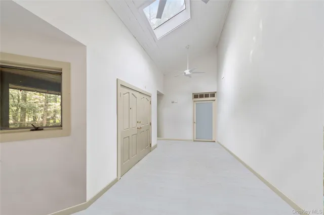 an empty room with windows and closet