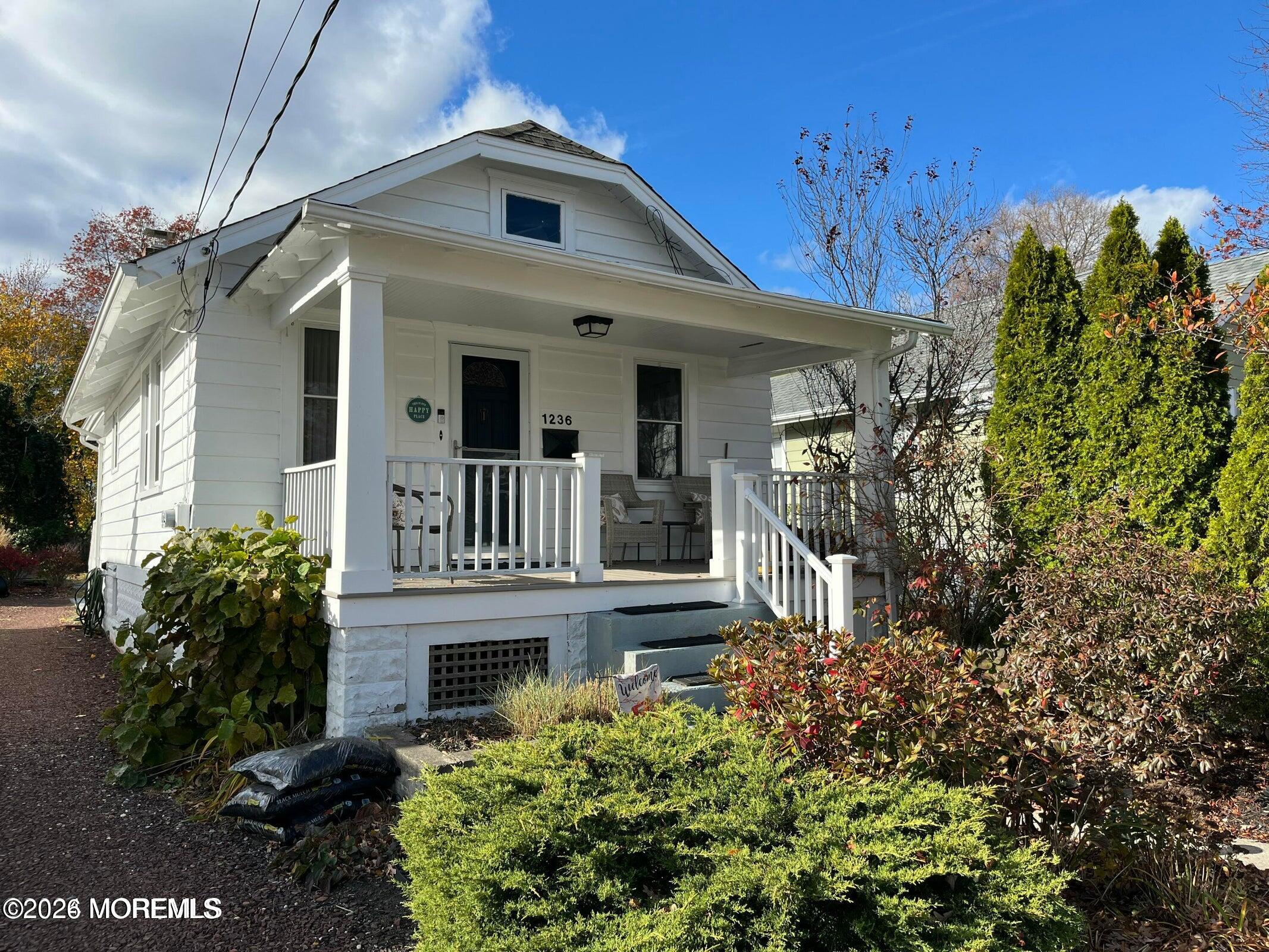 1236 Maplewood Road Belmar, NJ 07719 - Photo 2 of 44 a front view of a house with a garden