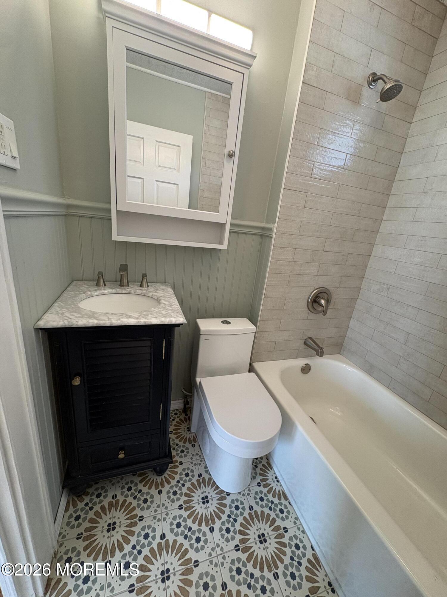 1236 Maplewood Road Belmar, NJ 07719 - Photo 21 of 44 a bathroom with a sink toilet a mirror and shower