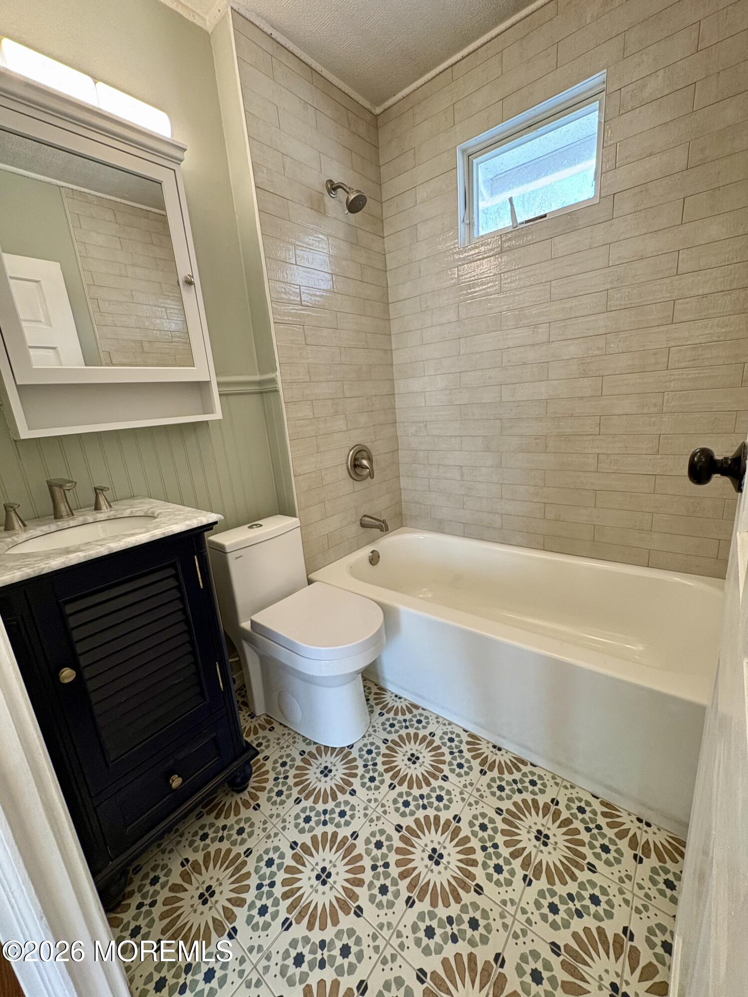 1236 Maplewood Road Belmar, NJ 07719 - Photo 22 of 44 a bathroom with a toilet a sink and bathtub