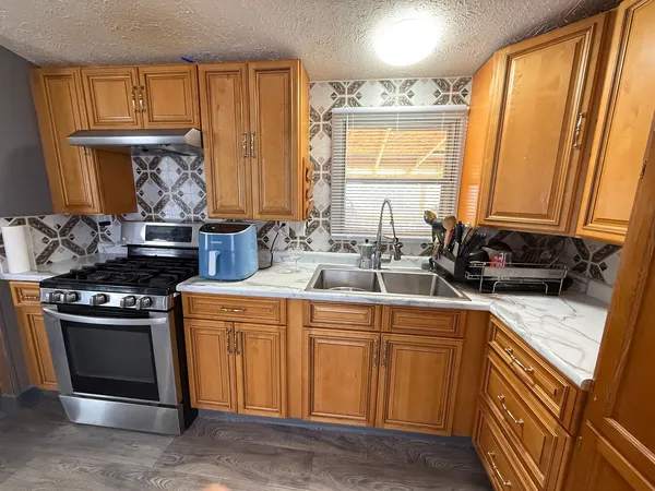a kitchen with a sink stove and cabinets