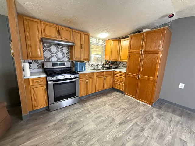 a kitchen with stainless steel appliances granite countertop a stove top oven