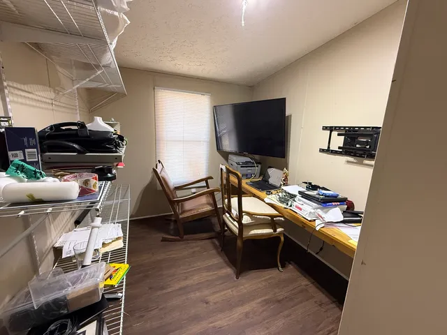 a room with furniture a flat screen tv and a table