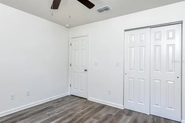 an empty room with a ceiling fan