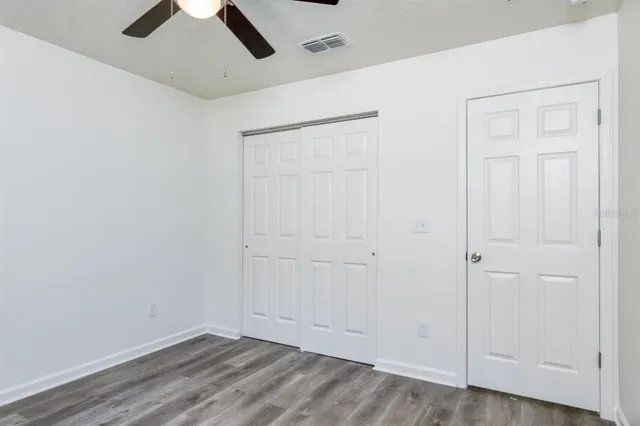 an empty room with a ceiling fan