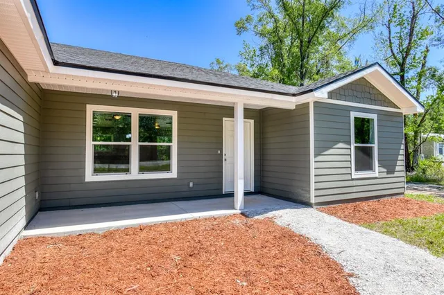 a front view of a house with a yard