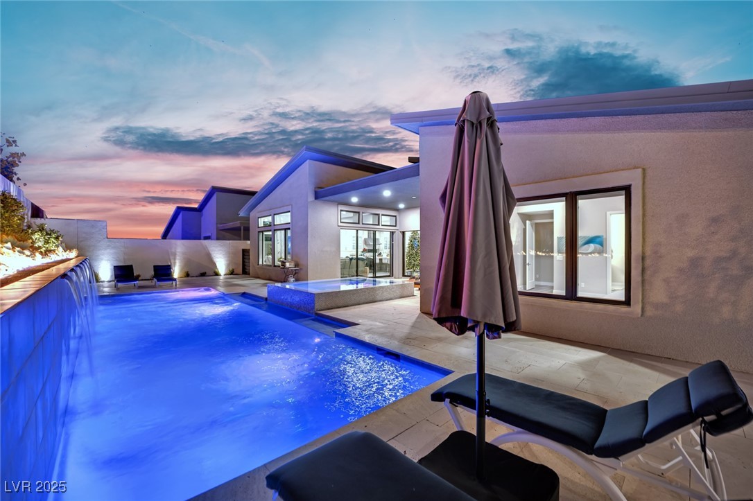 397 Highview Rdg Avenue Las Vegas, NV 89138 - Photo 22 of 97 Pool at dusk featuring a patio area and a pool with connected hot tub