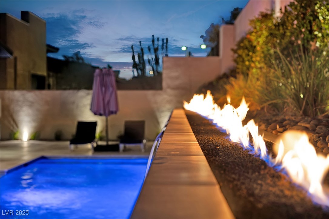 397 Highview Rdg Avenue Las Vegas, NV 89138 - Photo 25 of 97 Pool at dusk featuring a +/- 40 foot fire feature and an outdoor pool