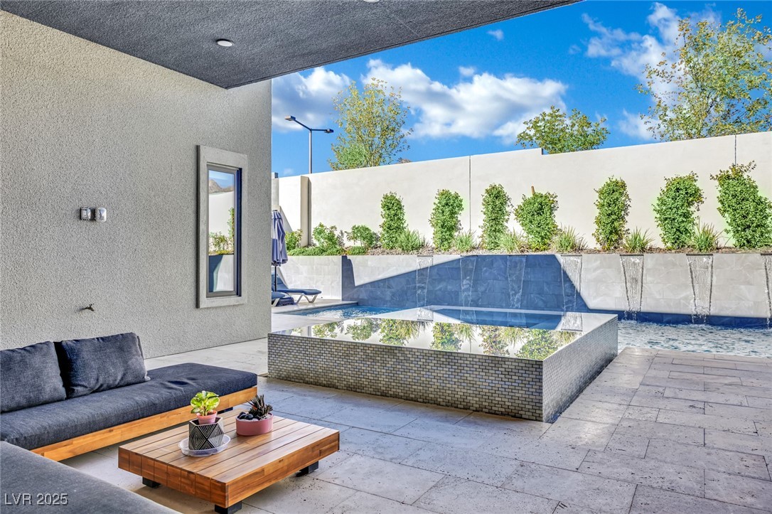 397 Highview Rdg Avenue Las Vegas, NV 89138 - Photo 34 of 97 Fenced backyard with a patio area and an outdoor living space