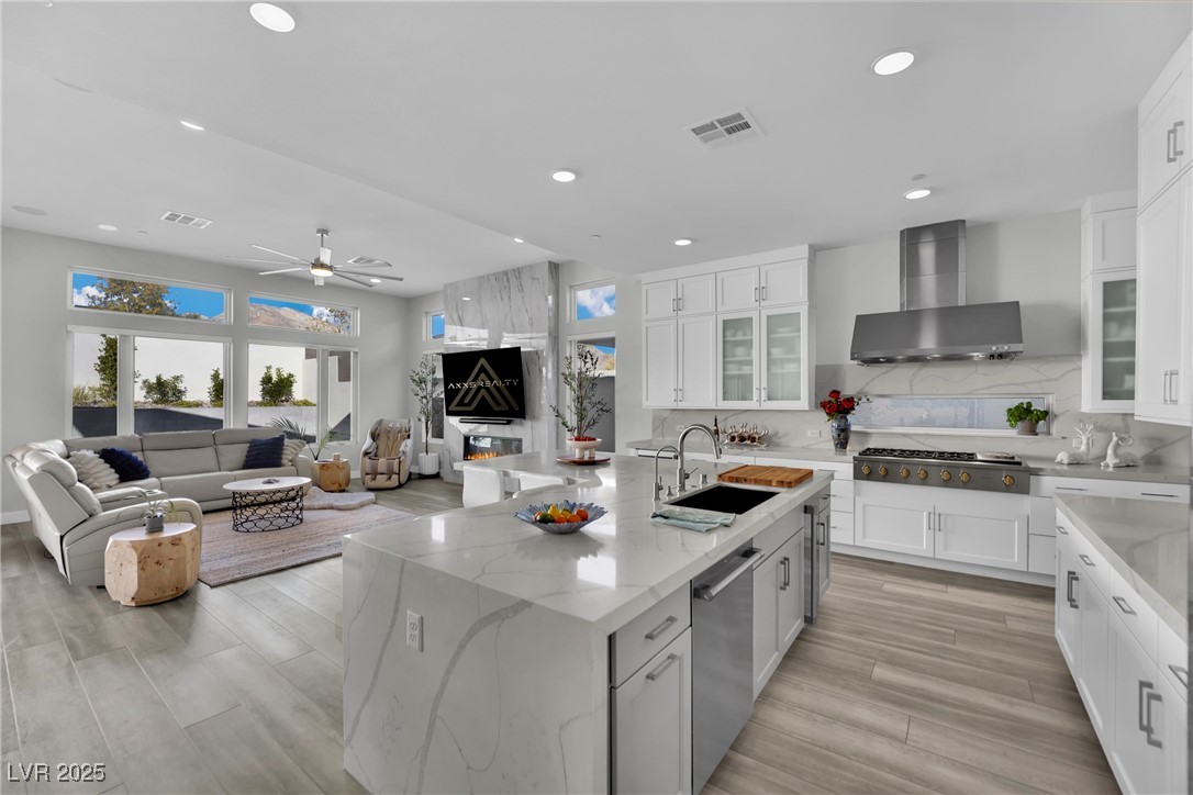 397 Highview Rdg Avenue Las Vegas, NV 89138 - Photo 36 of 97 Kitchen with white cabinets, glass insert cabinets, light stone counters, and recessed lighting