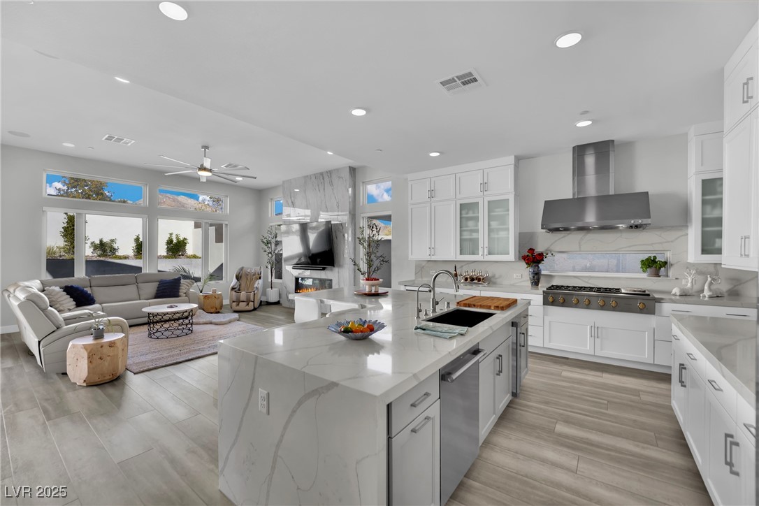 397 Highview Rdg Avenue Las Vegas, NV 89138 - Photo 37 of 97 Kitchen with white cabinetry, glass insert cabinets, light stone counters, ceiling fan, and recessed lighting