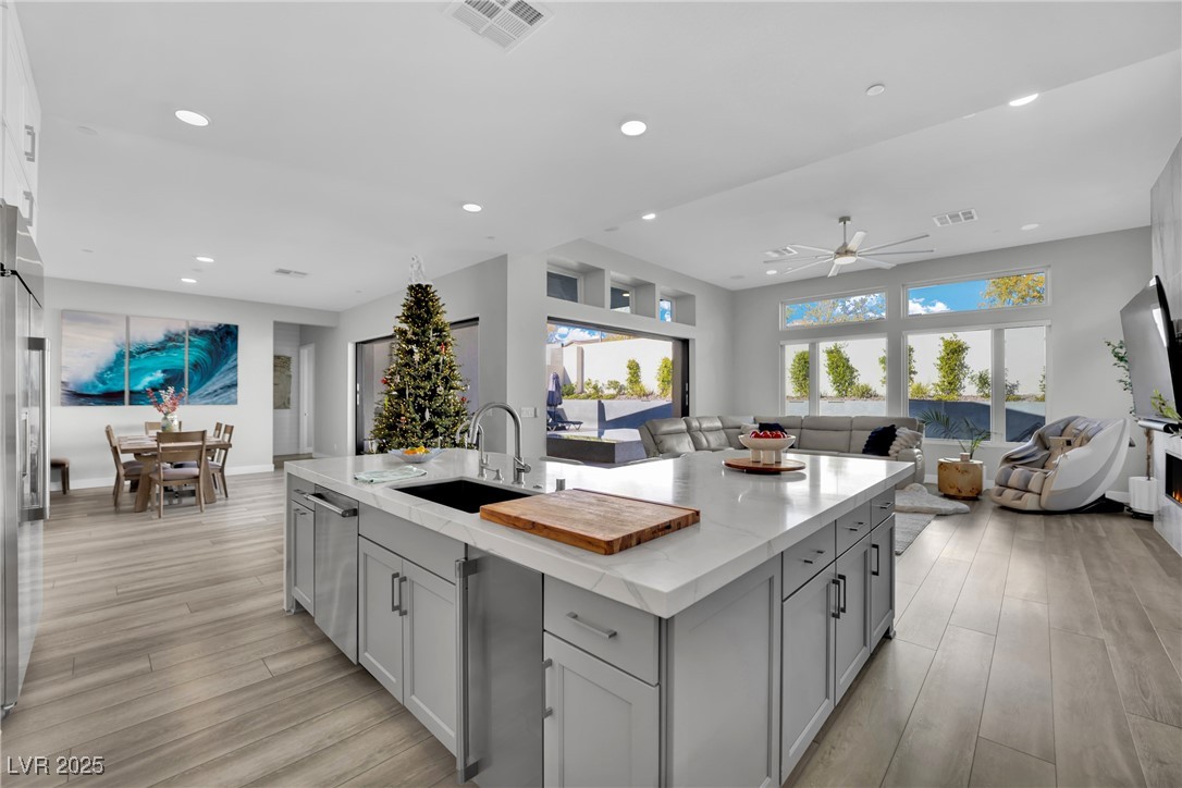 397 Highview Rdg Avenue Las Vegas, NV 89138 - Photo 96 of 97 Kitchen with open floor plan, light stone counters, light wood-style floors, a ceiling fan, and recessed lighting