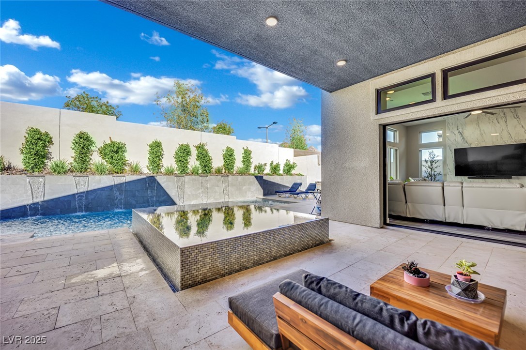 397 Highview Rdg Avenue Las Vegas, NV 89138 - Photo 4 of 97 View of pool featuring a covered patio, a fenced backyard, and an outdoor living space