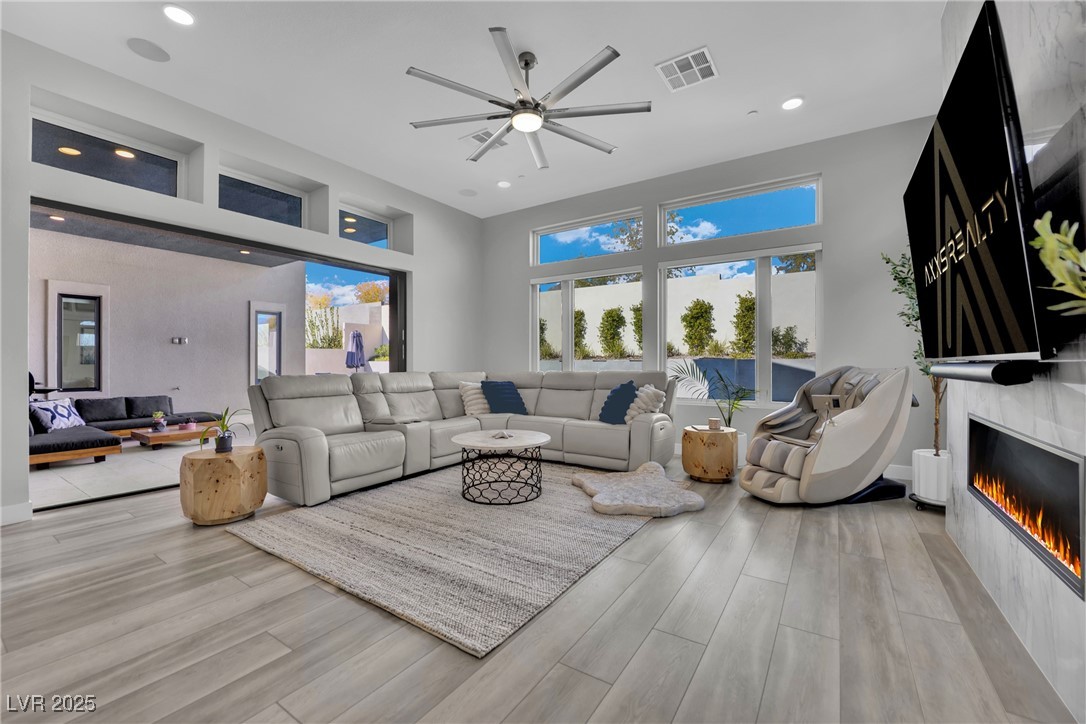 397 Highview Rdg Avenue Las Vegas, NV 89138 - Photo 45 of 97 Living area with wood finished floors, ceiling fan, a glass covered fireplace, and recessed lighting