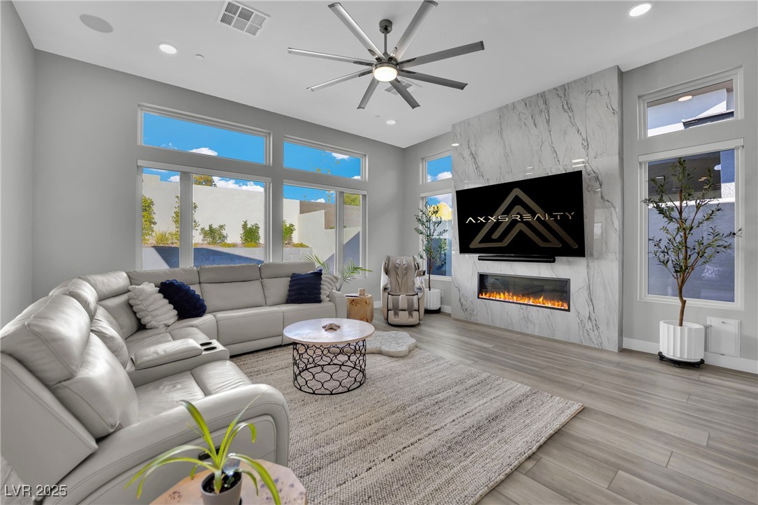 397 Highview Rdg Avenue Las Vegas, NV 89138 - Photo 47 of 97 Living area featuring ceiling fan, light wood-style flooring, a fireplace, and recessed lighting