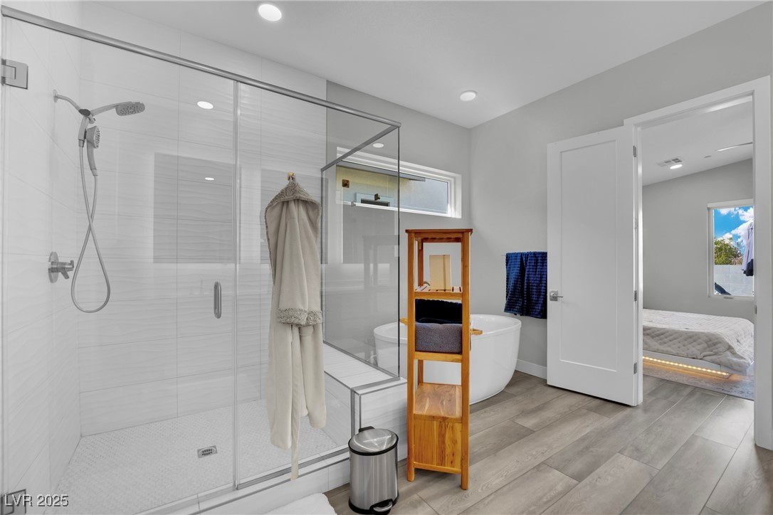 397 Highview Rdg Avenue Las Vegas, NV 89138 - Photo 68 of 97 Ensuite bathroom featuring a stall shower, a soaking tub, wood finished floors, and recessed lighting