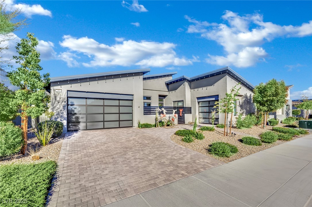 397 Highview Rdg Avenue Las Vegas, NV 89138 - Photo 79 of 97 Modern home with decorative driveway, stucco siding, and a garage