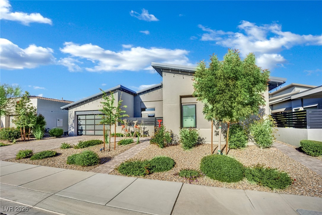 397 Highview Rdg Avenue Las Vegas, NV 89138 - Photo 80 of 97 Modern home featuring driveway, stucco siding, and a garage