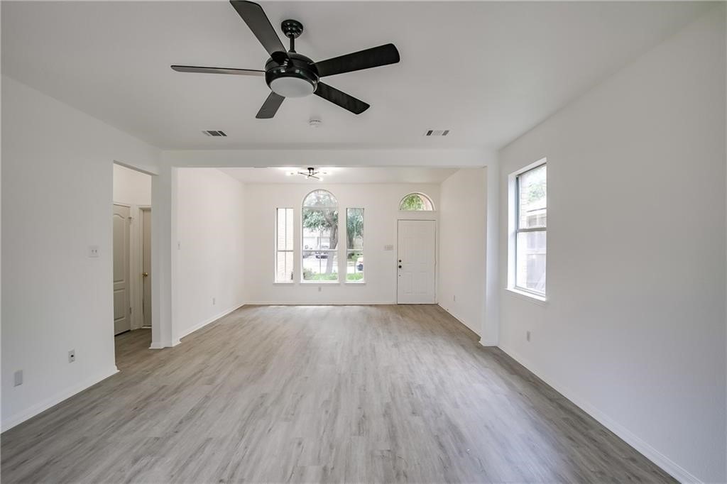 3524 Bratton Ridge Crossing Austin, TX 78728 - Photo 3 of 16 a view of empty room with wooden floor and fan