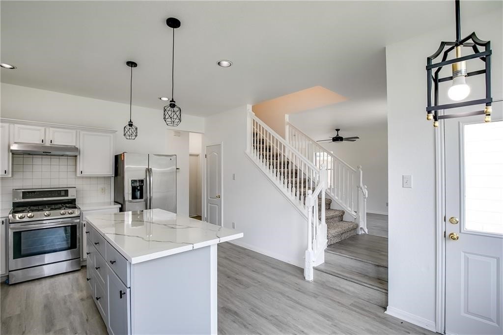 3524 Bratton Ridge Crossing Austin, TX 78728 - Photo 6 of 16 a kitchen with stainless steel appliances a stove a refrigerator and cabinets