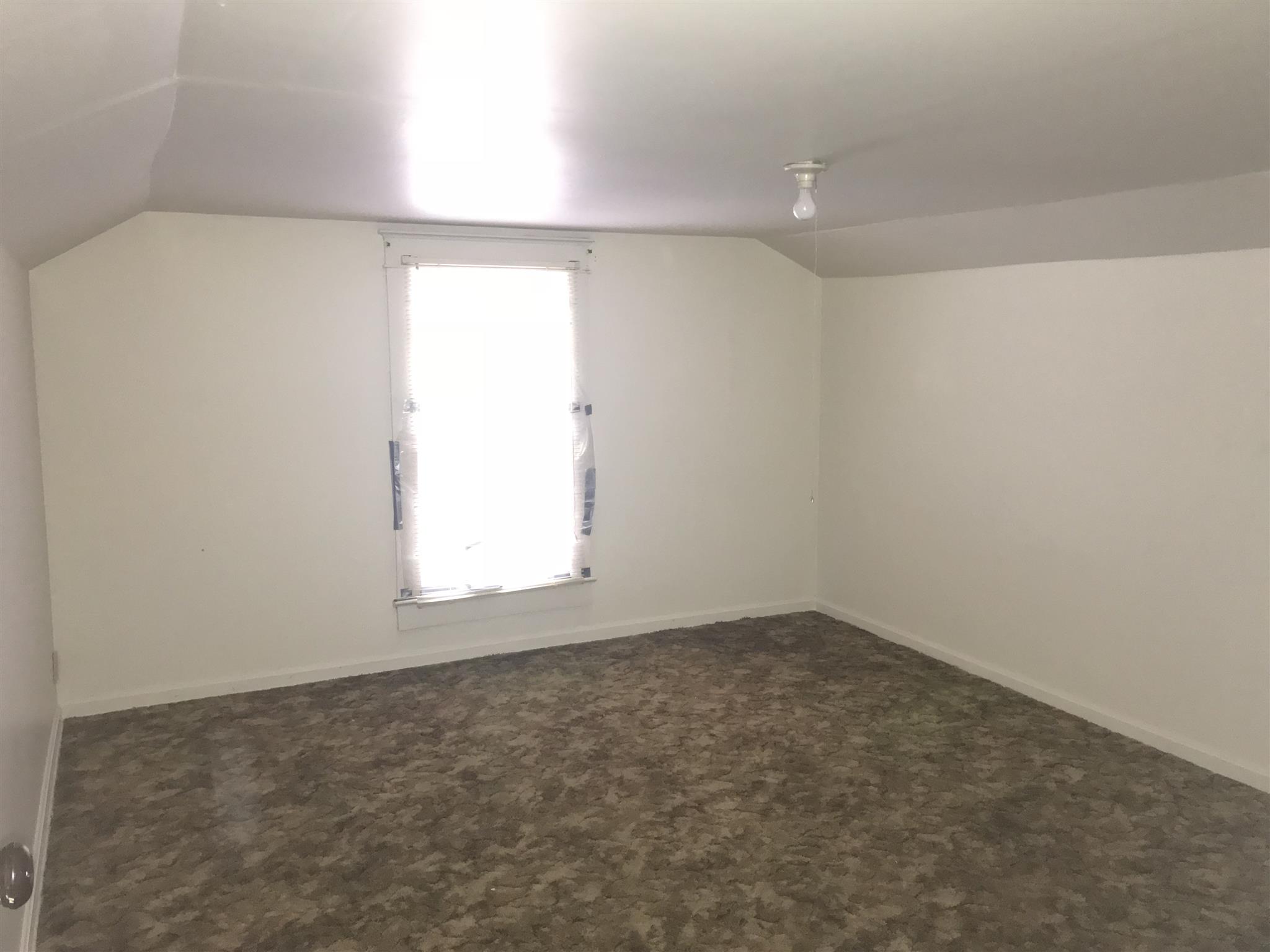 Upstairs room #1 used as a bedroom (no closet)