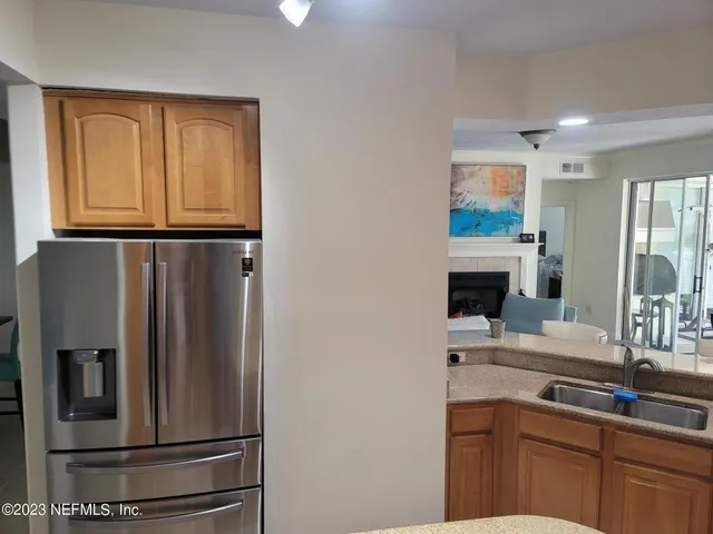 a kitchen with stainless steel appliances granite countertop a refrigerator and a sink