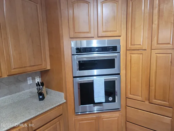 a kitchen with granite countertop stainless steel appliances and cabinets