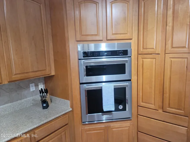 a kitchen with granite countertop stainless steel appliances and cabinets