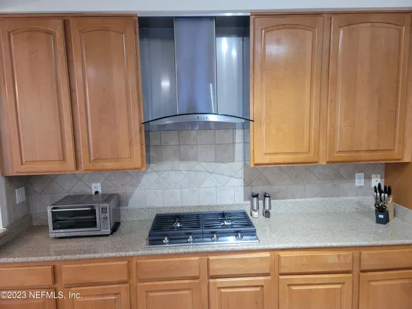 a kitchen with granite countertop cabinets and stainless steel appliances