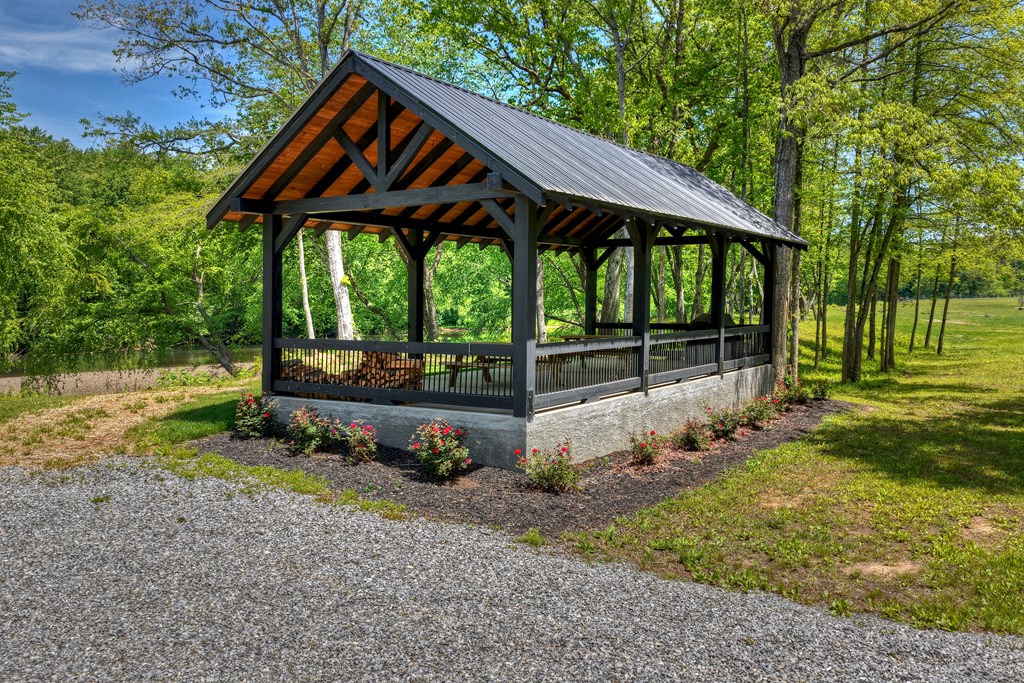 Lot 4 Grassy Creek Road Copperhill, TN 37317 - Photo 8 of 25 a backyard of a house with table and chairs