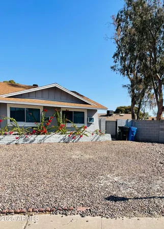 a view of a house with a yard and sitting area