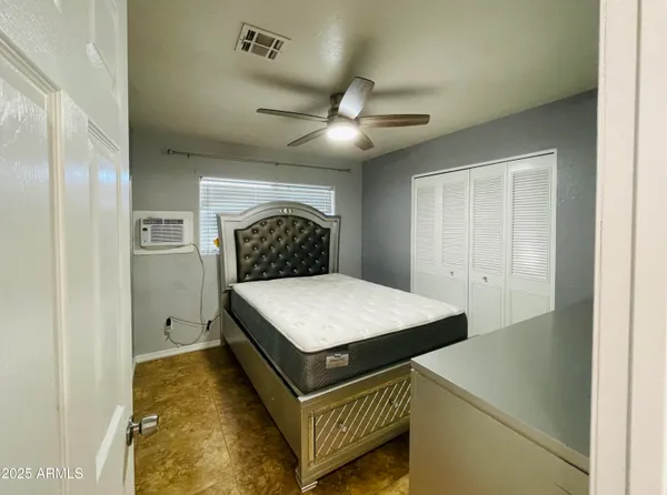 a bedroom with a bed and a ceiling fan