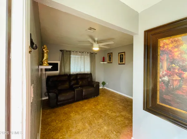 a living room with a large window and furniture