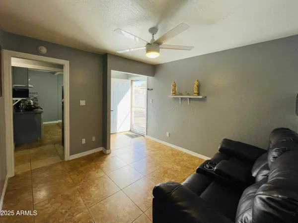 a living room with a couch and a ceiling fan