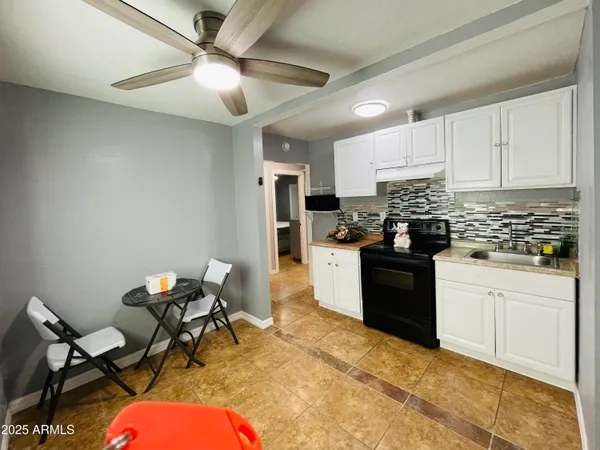 a kitchen with stainless steel appliances kitchen island granite countertop a sink and cabinets